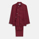 The Turnbull & Asser Burgundy Linen Modern Pyjama Set features a button-up, collared long-sleeve top with black piping and three pockets, plus matching pants with an elastic waistband.