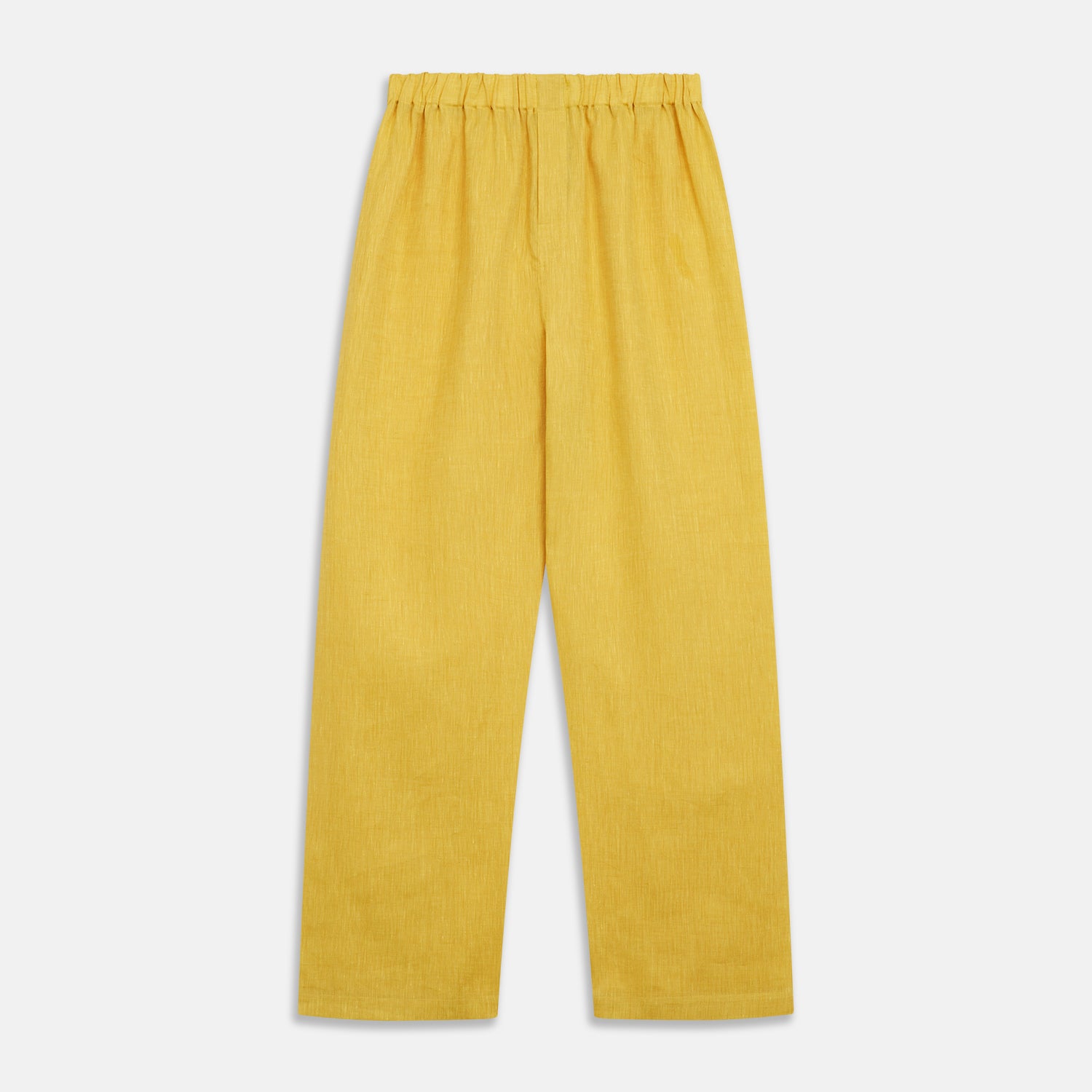 View 7 of product A barefoot person stands against a plain background, wearing the Turnbull & Asser Ochre Linen Modern Pyjama Set with black piping on the collar, cuffs, and pockets. The button-down top completes the look as they gaze to the side.