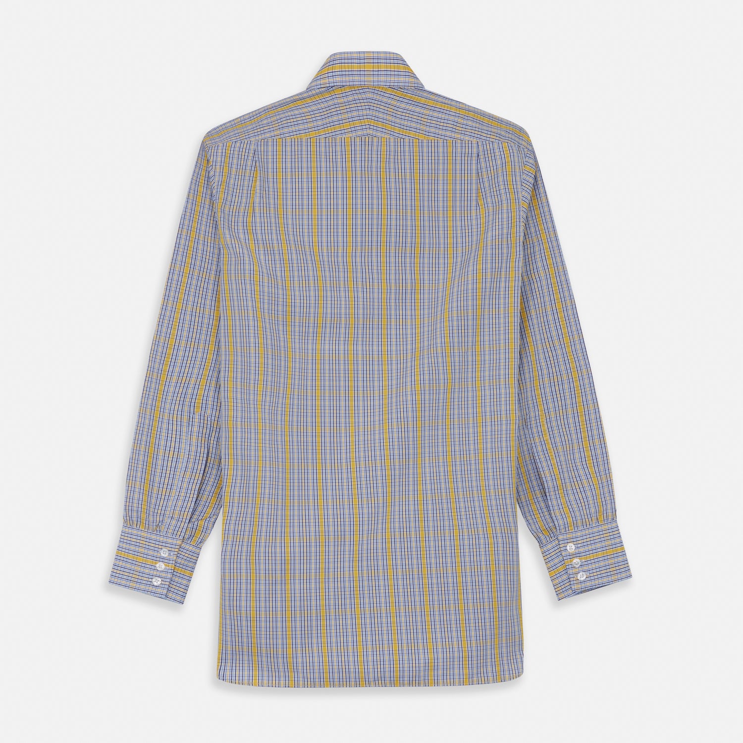 View 7 of product A man stands against a light background, wearing a Turnbull & Asser Yellow and Blue Fancy Check Regular Fit Shirt with T&A Collar, a patterned tie, dark dress pants, and black shoes. He faces forward with hands in pockets and a neutral expression.