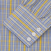 View 5 of product A man stands against a light background, wearing a Turnbull & Asser Yellow and Blue Fancy Check Regular Fit Shirt with T&A Collar, a patterned tie, dark dress pants, and black shoes. He faces forward with hands in pockets and a neutral expression.