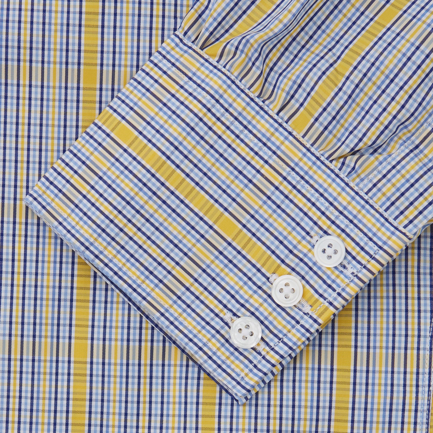 View 5 of product A man stands against a light background, wearing a Turnbull & Asser Yellow and Blue Fancy Check Regular Fit Shirt with T&A Collar, a patterned tie, dark dress pants, and black shoes. He faces forward with hands in pockets and a neutral expression.