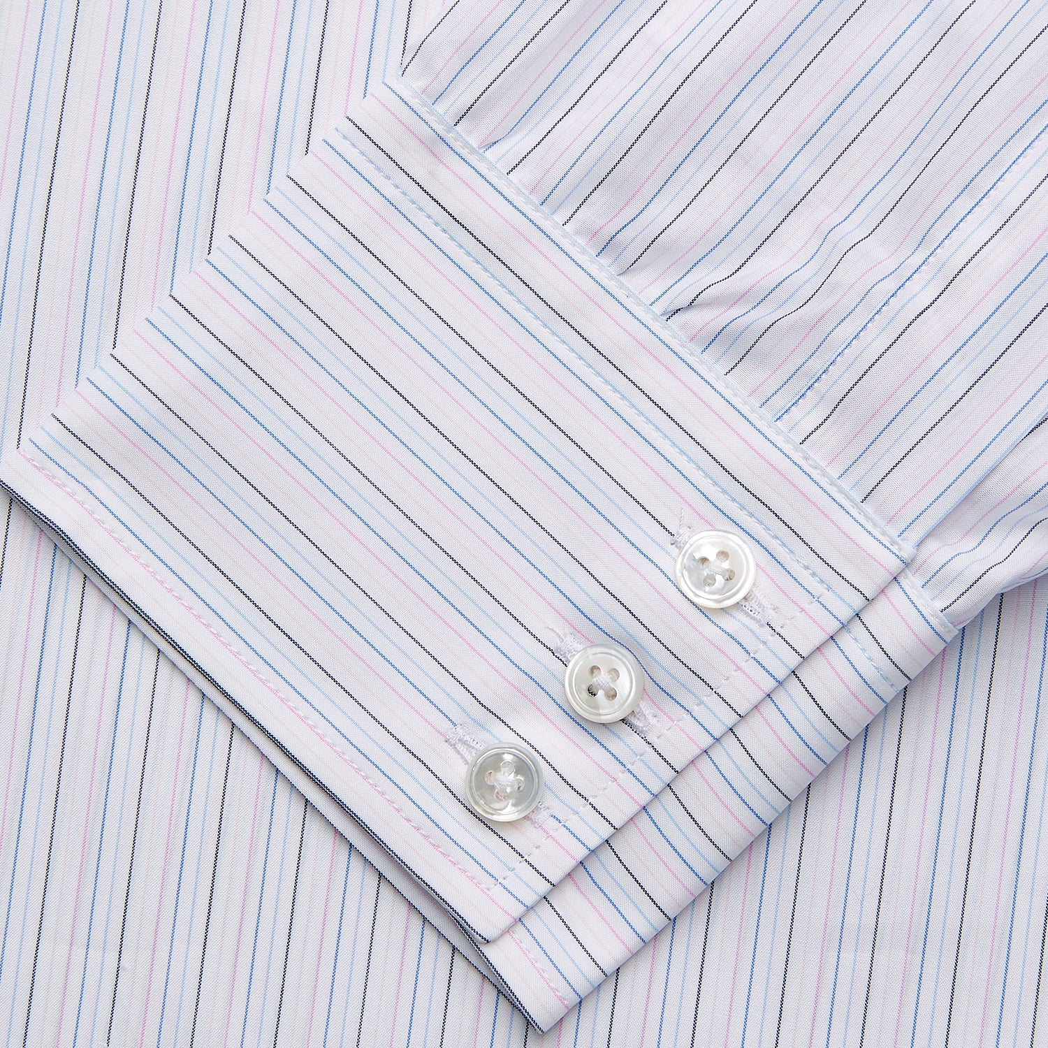 View 3 of product The Turnbull & Asser Blue Multi Stripe Regular Fit Mayfair Shirt features light blue vertical stripes on white, a classic collar, long sleeves, and buttoned cuffs, displayed on a plain white surface.