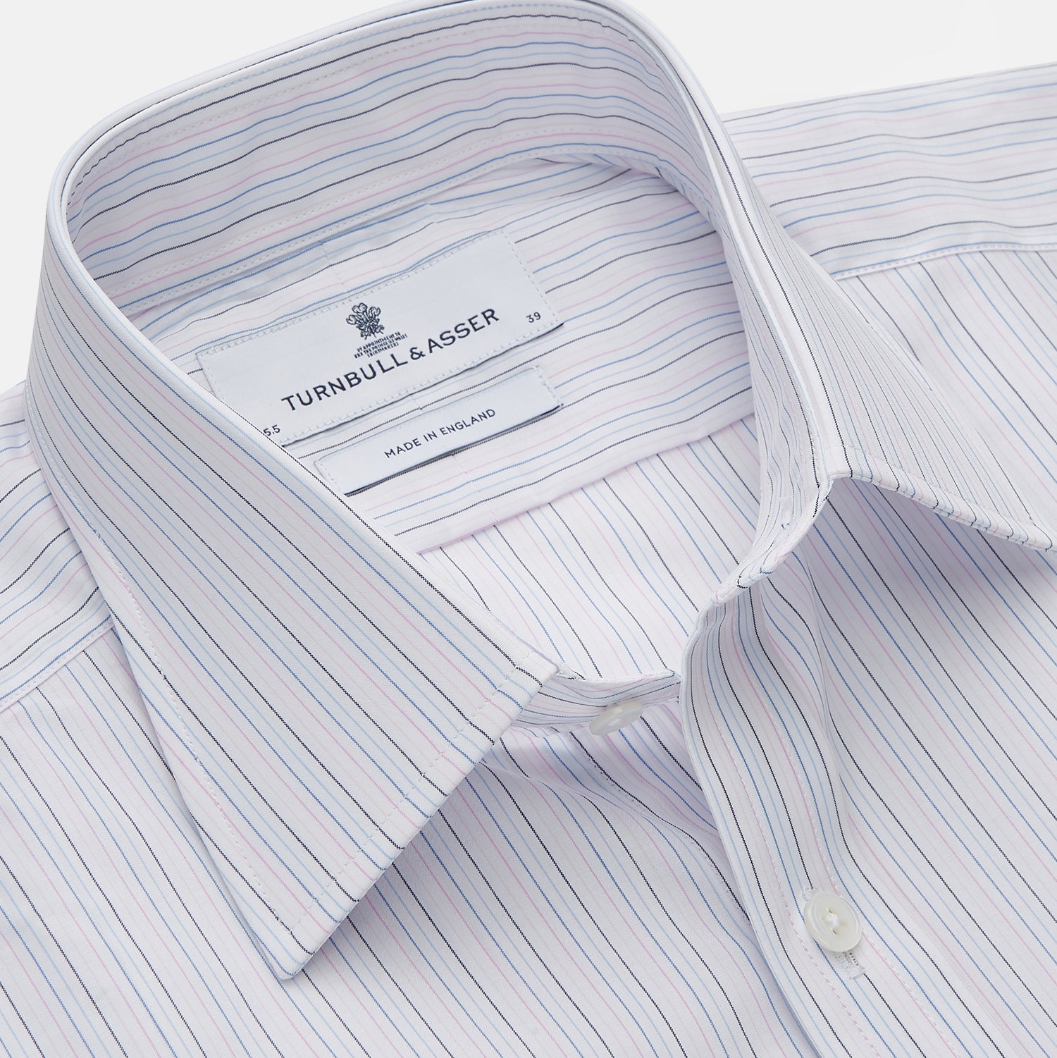 View 2 of product The Turnbull & Asser Blue Multi Stripe Regular Fit Mayfair Shirt features light blue vertical stripes on white, a classic collar, long sleeves, and buttoned cuffs, displayed on a plain white surface.