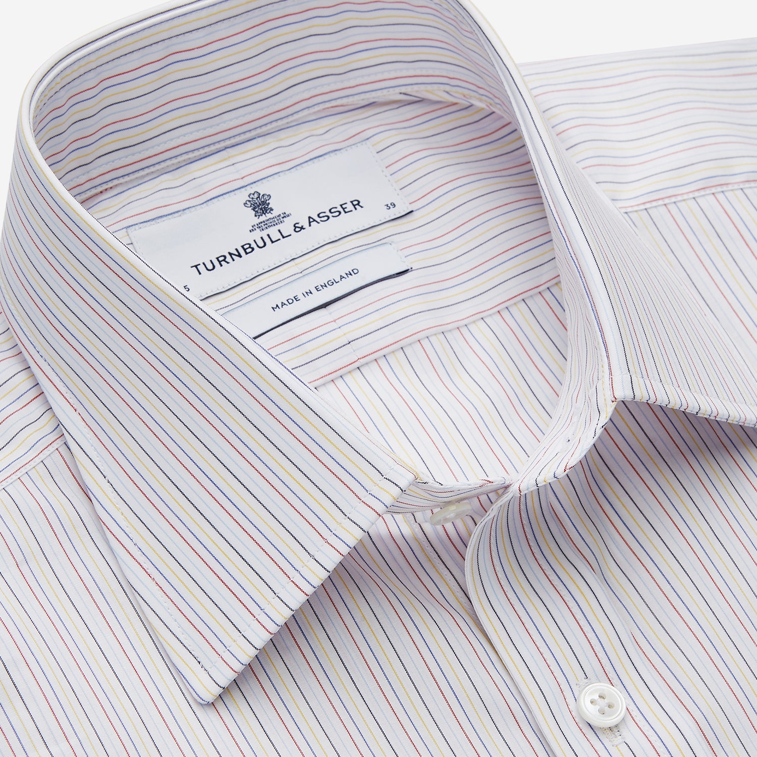 View 2 of product The Turnbull & Asser Red Multi Stripe Regular Fit Mayfair Shirt features long sleeves, a button-down design, classic collar, and subtle red vertical stripes on white, shown laid flat.