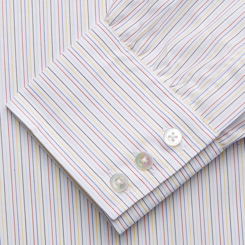 The Turnbull & Asser Red Multi Stripe Regular Fit Mayfair Shirt features long sleeves, a button-down design, classic collar, and subtle red vertical stripes on white, shown laid flat.