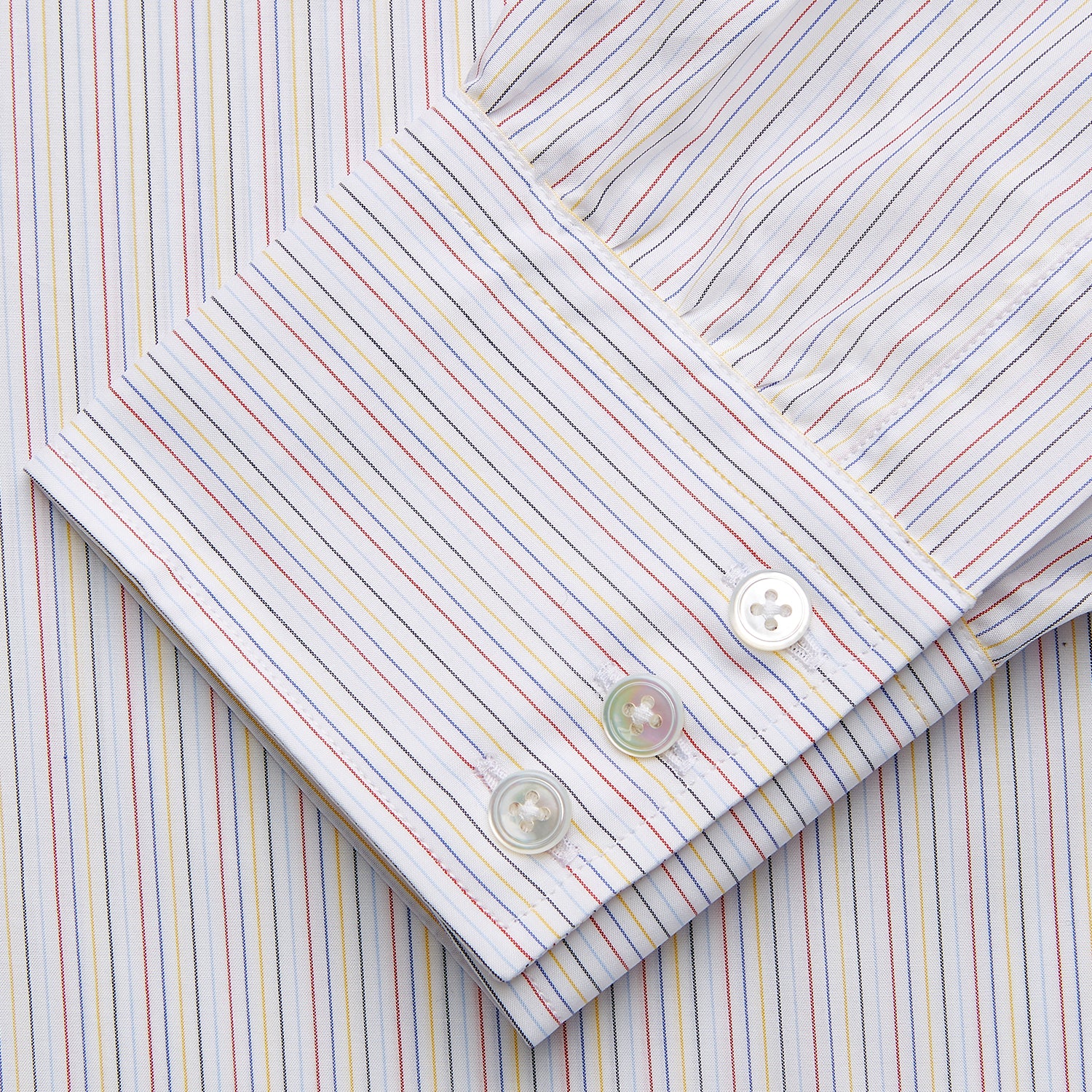 View 3 of product The Turnbull & Asser Red Multi Stripe Regular Fit Mayfair Shirt features long sleeves, a button-down design, classic collar, and subtle red vertical stripes on white, shown laid flat.