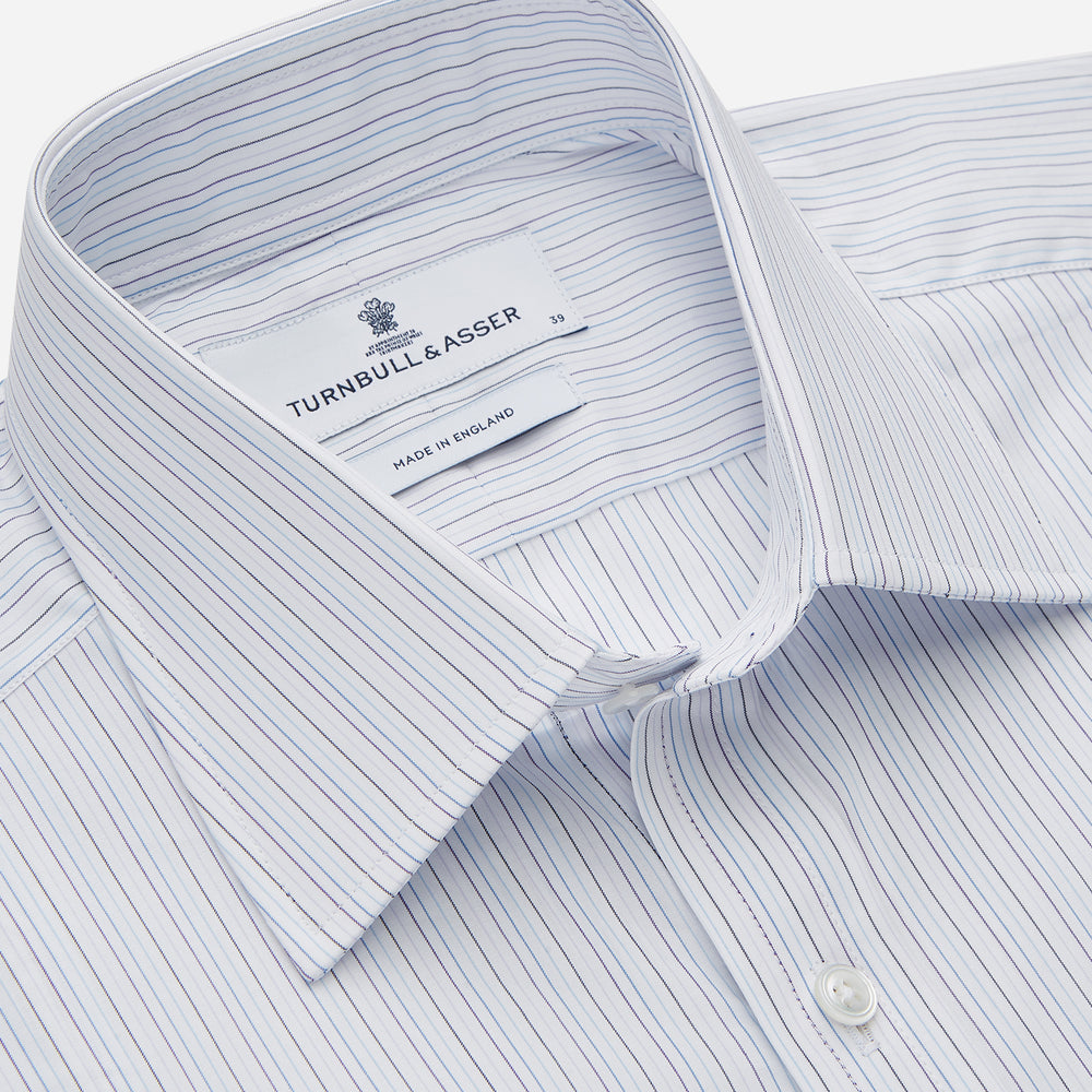The Purple Multi Stripe Regular Fit Mayfair Shirt by Turnbull & Asser features long sleeves, a classic collar, and buttoned cuffs—perfect for achieving a refined yet relaxed style.