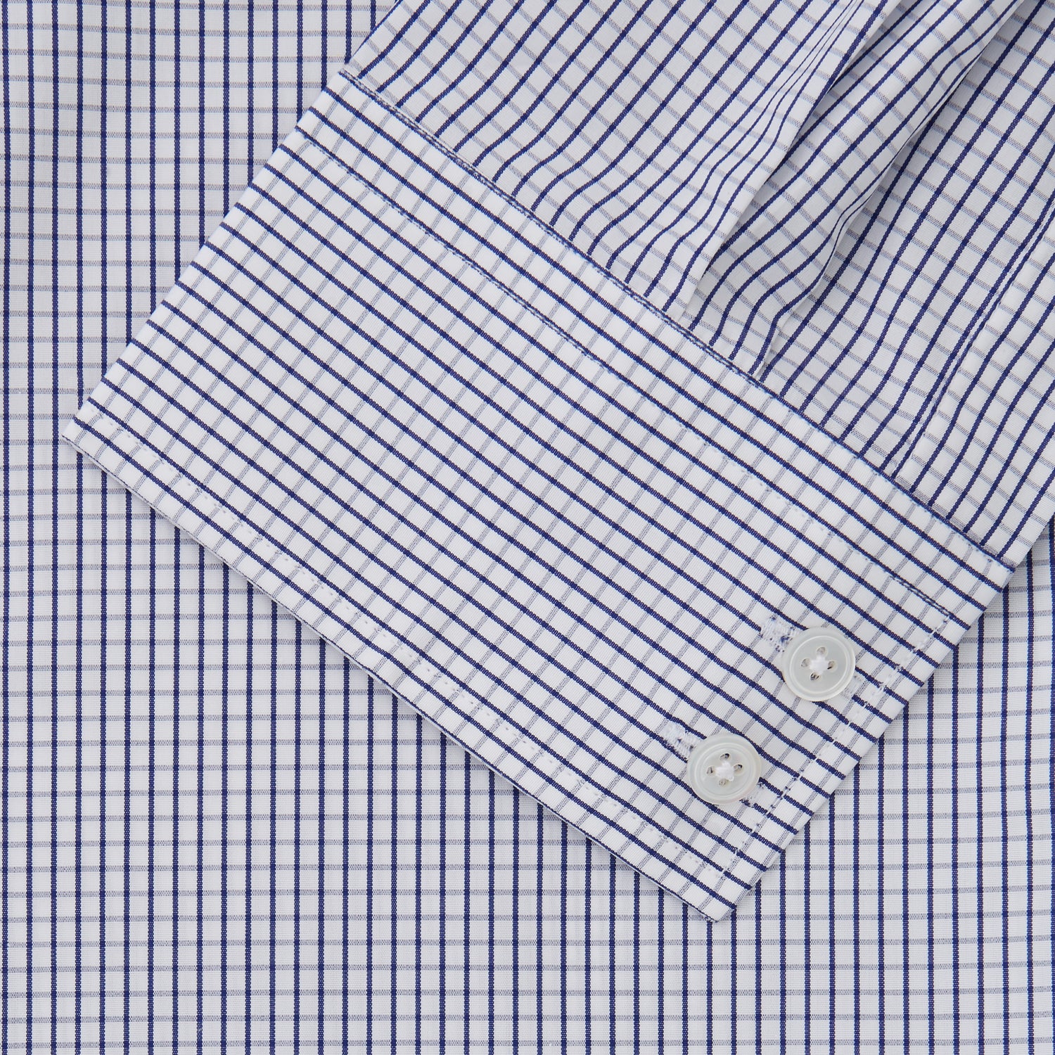 View 3 of product The Turnbull & Asser Blue Check Tailored Fit Shirt features a Kent collar, 2-button cuffs, and white buttons. Made from fine Italian cotton with a small blue and white checkered pattern, it's displayed on a plain white background.
