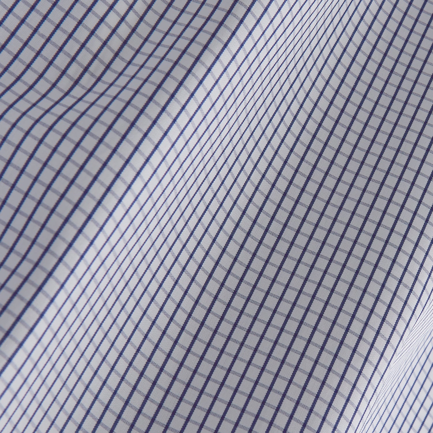 View 4 of product The Turnbull & Asser Blue Check Tailored Fit Shirt features a Kent collar, 2-button cuffs, and white buttons. Made from fine Italian cotton with a small blue and white checkered pattern, it's displayed on a plain white background.