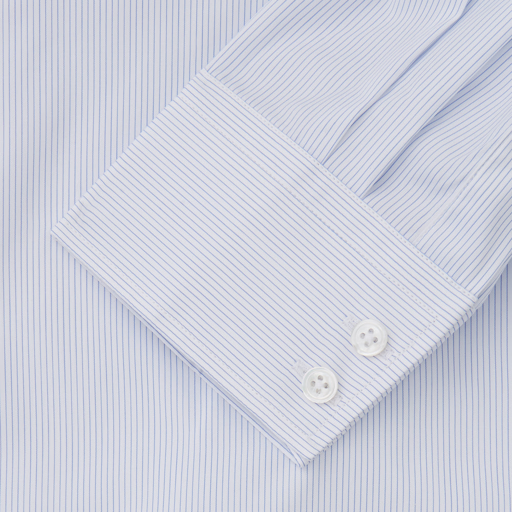 The Turnbull & Asser Sky Blue Bengal Stripe Tailored Fit Shirt features a Kent collar and 2-button cuffs, displayed neatly flat against a white background.