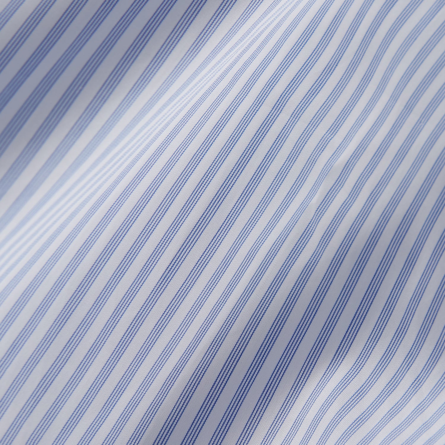View 4 of product The Turnbull & Asser Sky Blue and White Stripe Tailored Fit Shirt features a Kent collar, 2-button cuffs, and is crafted from fine Italian cotton, shown flat against a plain background.