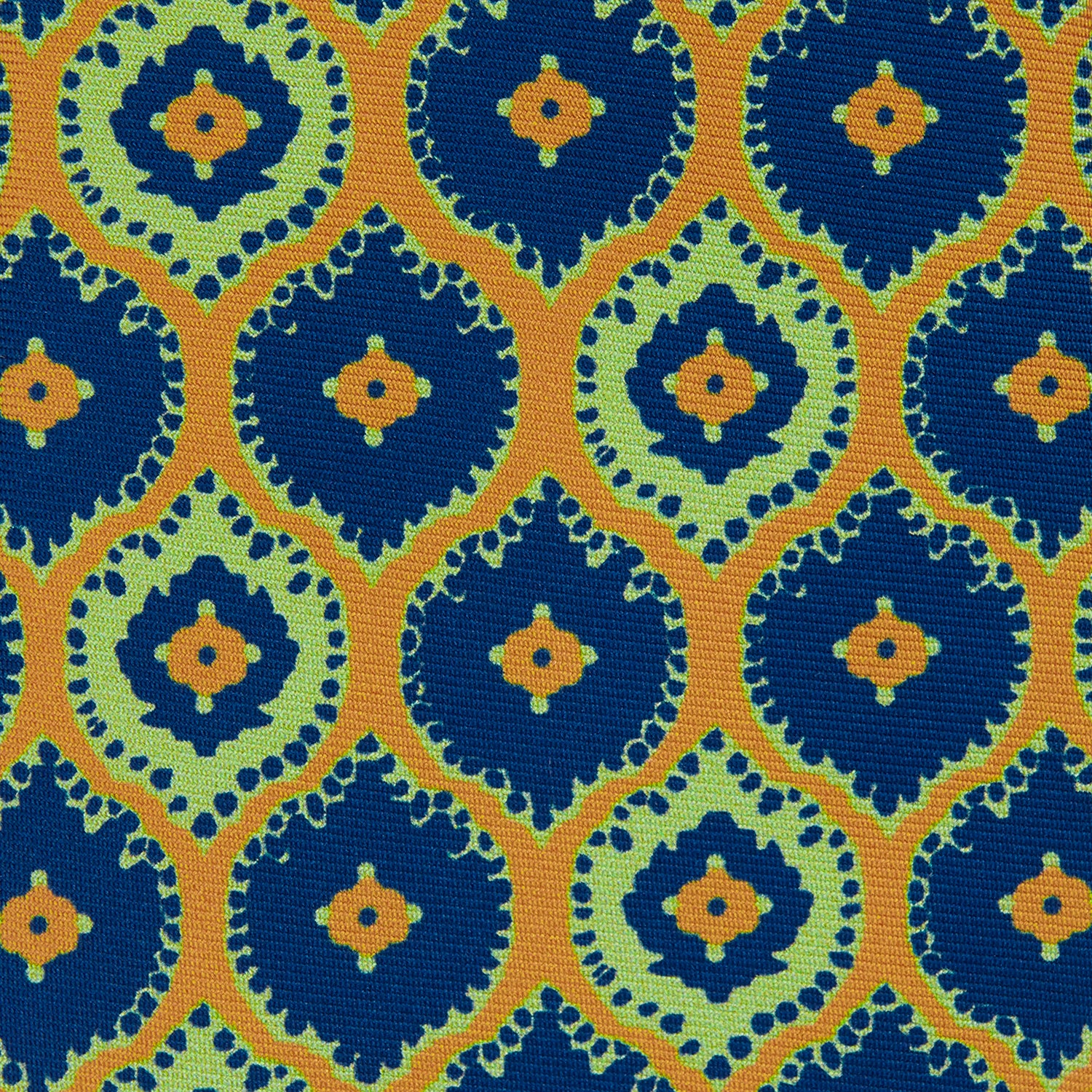 View 3 of product The Yellow Medallion Printed Silk Tie by Turnbull & Asser features a bold abstract medallion pattern in blue, green, and orange on yellow silk, displayed rolled up against a plain white background.