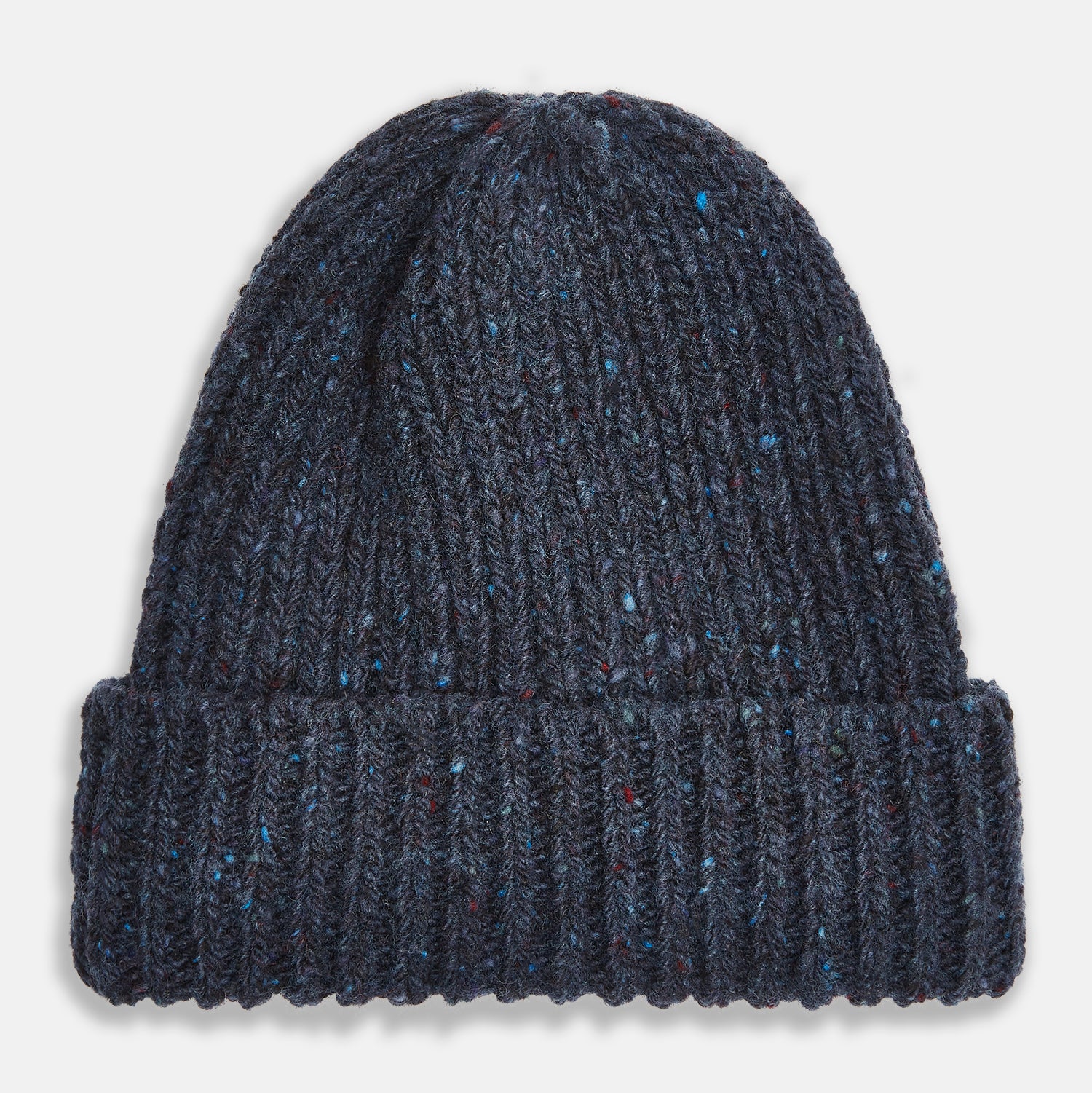 View 1 of product The Turnbull & Asser Navy Donegal Ribbed Merino Hat features thick ribbed knitting, a folded brim, and subtle lighter blue and red flecks throughout the merino yarn, shown against a plain white background.
