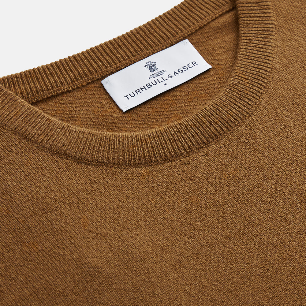 The Vicuna Glenn Cashmere Crew Neck Jumper by Turnbull & Asser is a brown crew neck sweater with long sleeves, ribbed cuffs, hem, and neckline, displayed flat on a white background for a classic look.