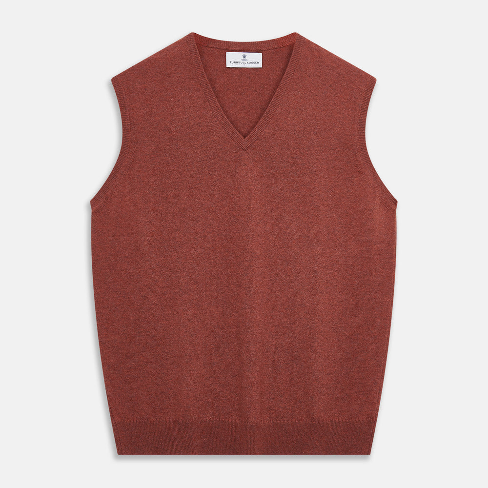 The Turnbull & Asser Burgundy Ifor Cashmere Slipover, a sleeveless V-neck design in fine knit, is shown laid flat on a white background; the neck lining displays a small label, highlighting its Scottish craftsmanship.