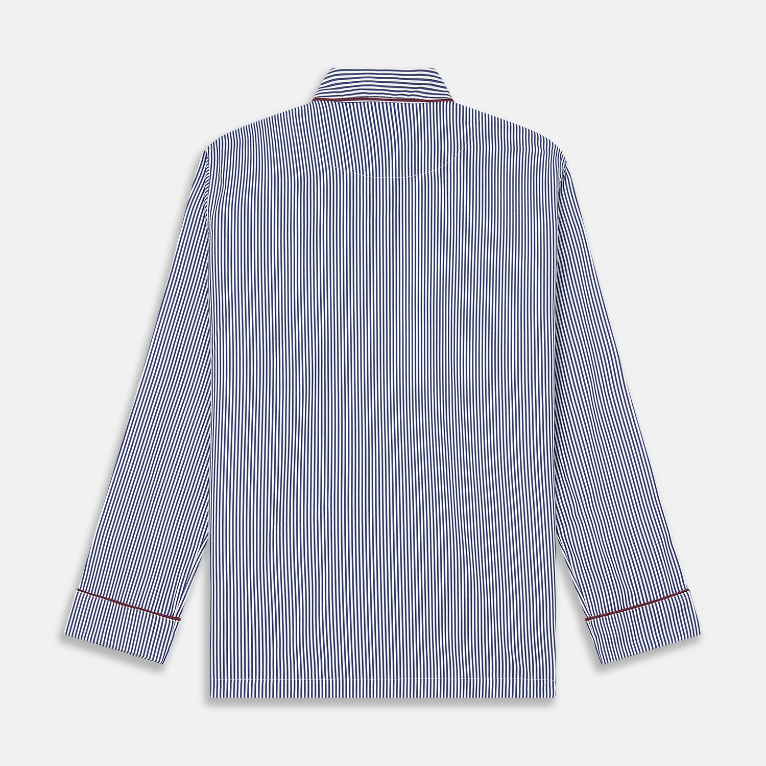 View 6 of product The Turnbull & Asser Navy & White Stripe Cotton Modern Pyjama Set features blue and white Bengal stripes with red piping, a long-sleeve button-up top, chest pocket, and matching pants. Shown laid flat on a white background.