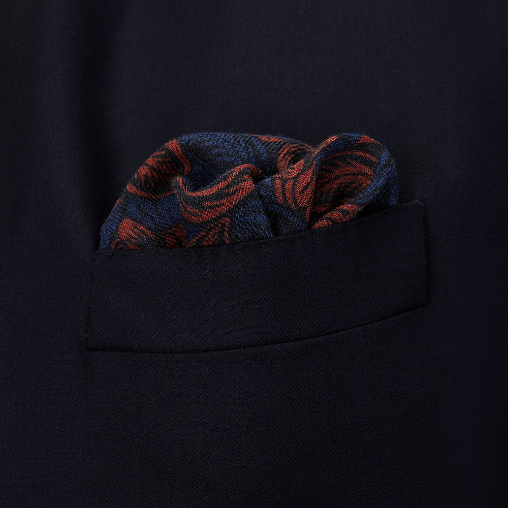The Turnbull & Asser Navy Multi Camo Birds Wool Twill Pocket Square features a colorful camo bird pattern on navy wool twill with multicolor borders and a geometric edge design. Made in Italy.