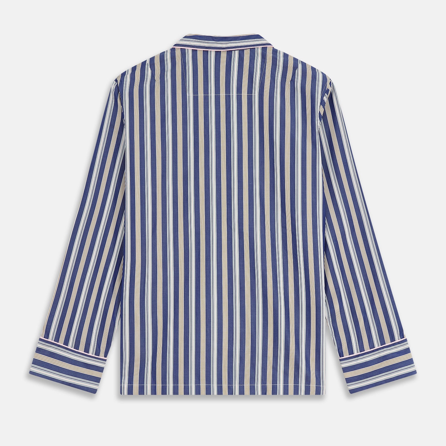 View 8 of product A person stands barefoot on a gray floor in the Turnbull & Asser Blue Multi Stripe Harriet Women’s Pyjama Set with a dark sweater over their shoulders—premium cotton pyjamas that make a perfect gift for her—against a plain beige background.
