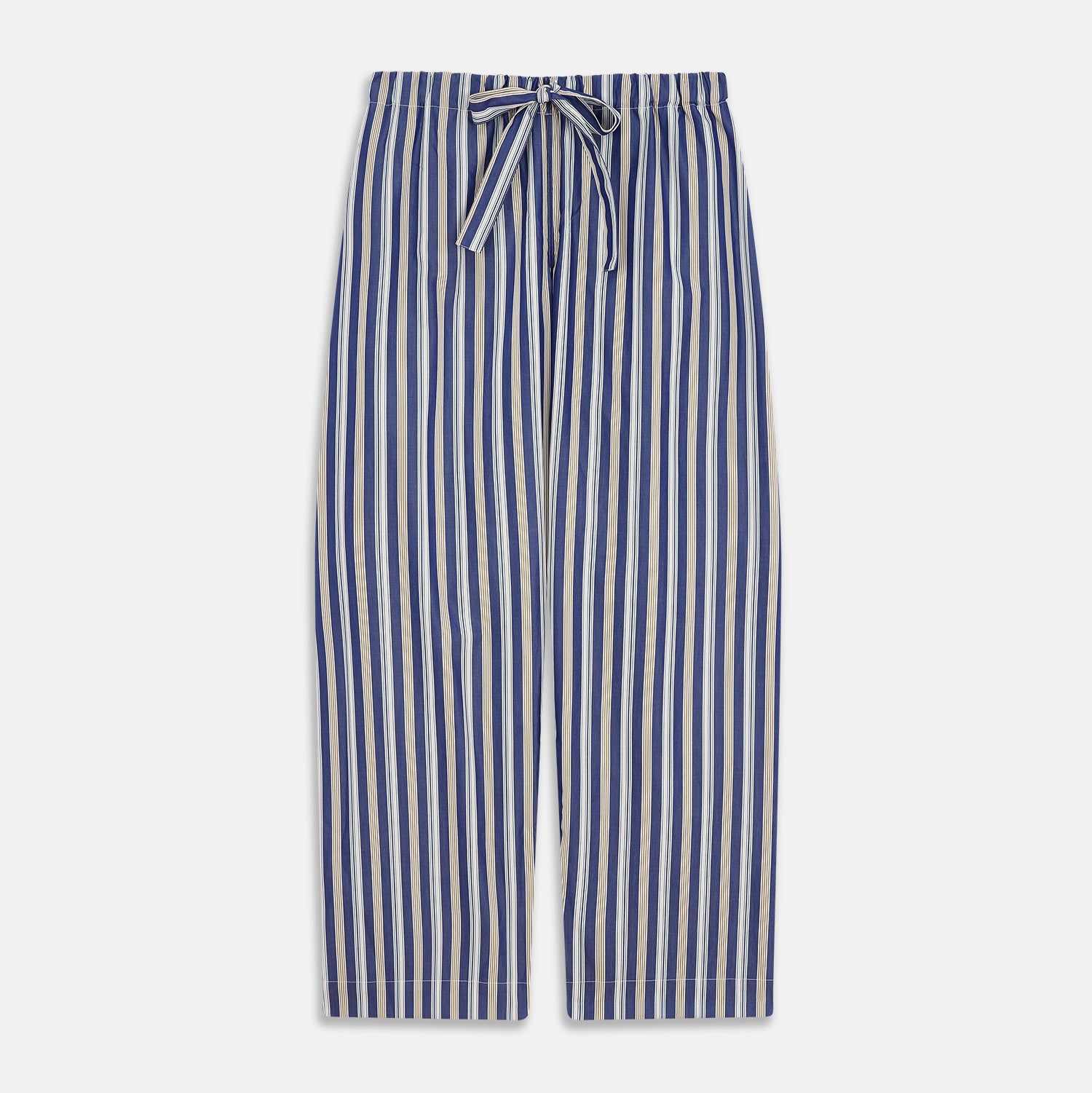 View 7 of product A person stands barefoot on a gray floor in the Turnbull & Asser Blue Multi Stripe Harriet Women’s Pyjama Set with a dark sweater over their shoulders—premium cotton pyjamas that make a perfect gift for her—against a plain beige background.