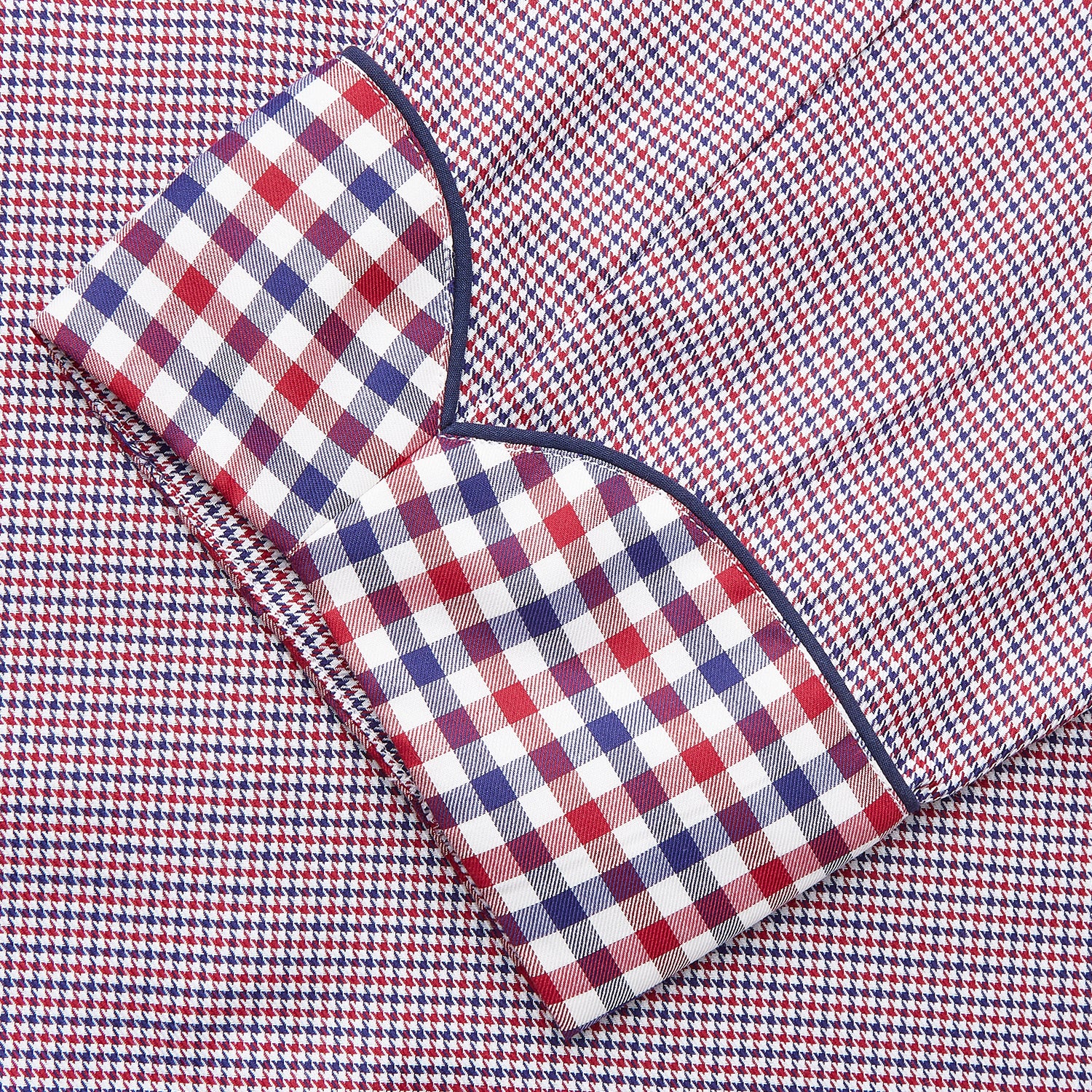 View 3 of product The Turnbull & Asser Burgundy Multi Check Contrast Cotton Gown features a long silhouette with a shawl collar, waist tie, and three pockets, accented by red, black, and white checkered trim—ideal for luxurious nights at home.