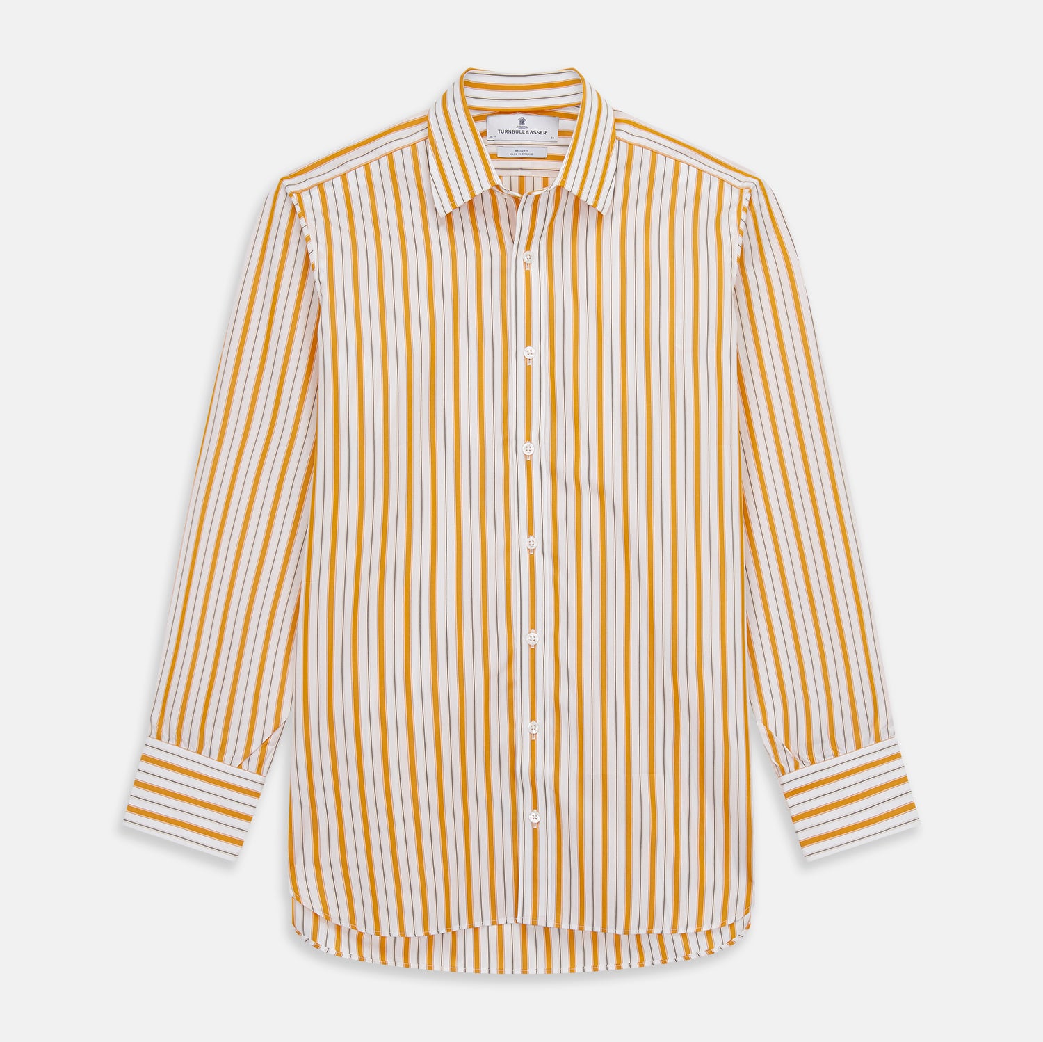View 2 of product A man stands against a tan background wearing a Turnbull & Asser Orange Multi Stripe Regular Fit Shirt with T&A Collar and 3 Button Cuffs, paired with tan dress pants, brown belt, and brown shoes. He faces forward with a neutral expression.