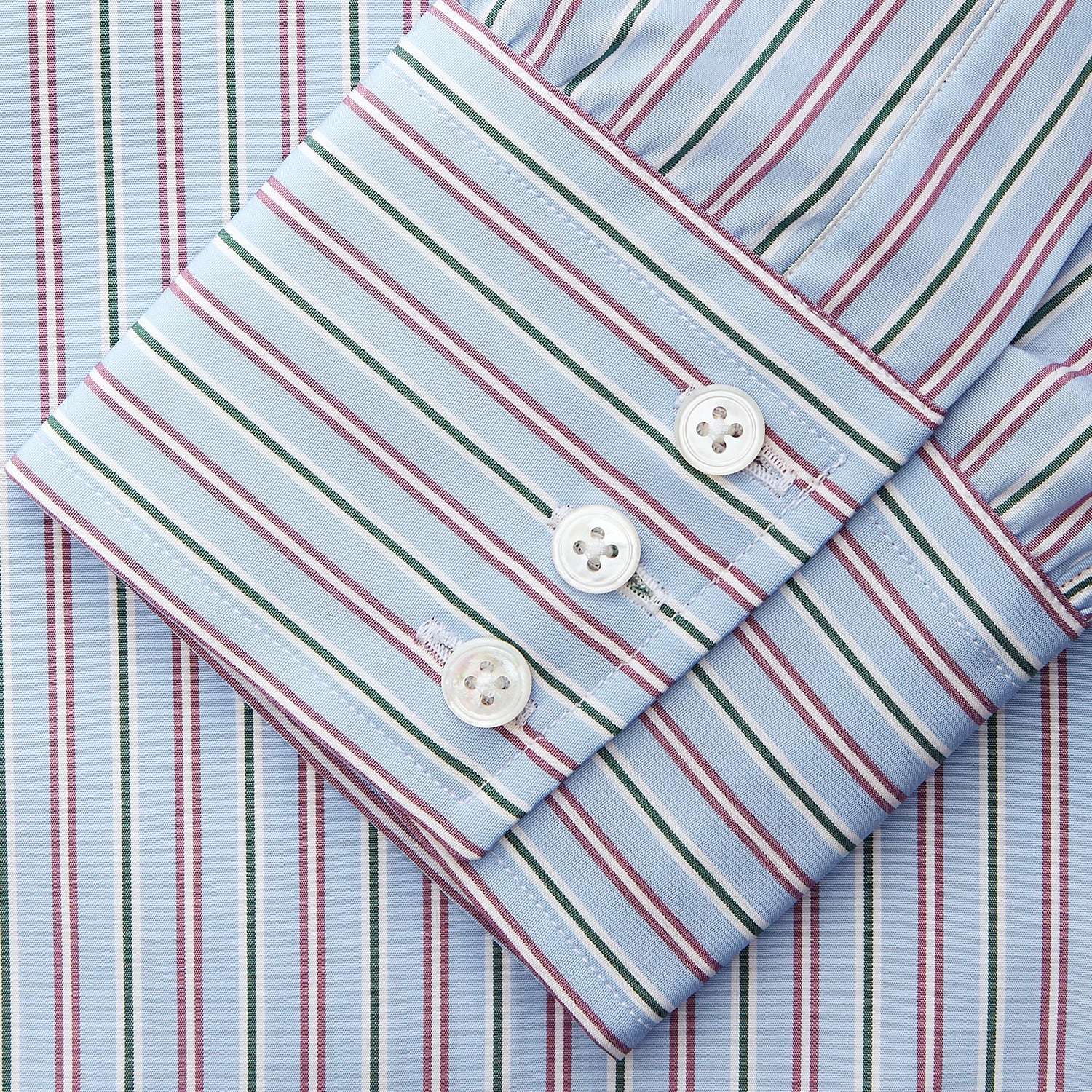 View 3 of product The Turnbull & Asser Blue, Purple & Green Stripe Regular Fit Shirt features a T&A collar and 3 button cuffs, laid flat on a white surface.