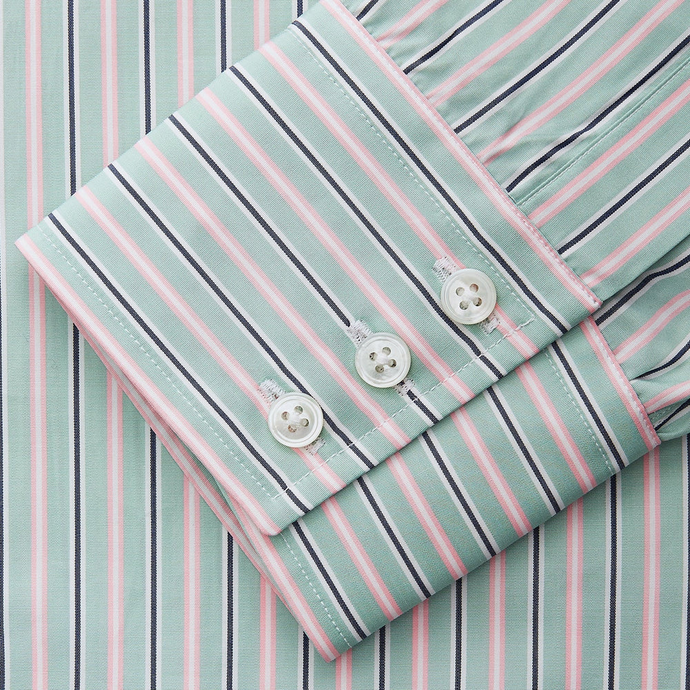 The Turnbull & Asser Green, Navy & Pink Stripe Regular Fit Shirt features a T&A collar, 3 button cuffs, and bold vertical stripes for a classic look.