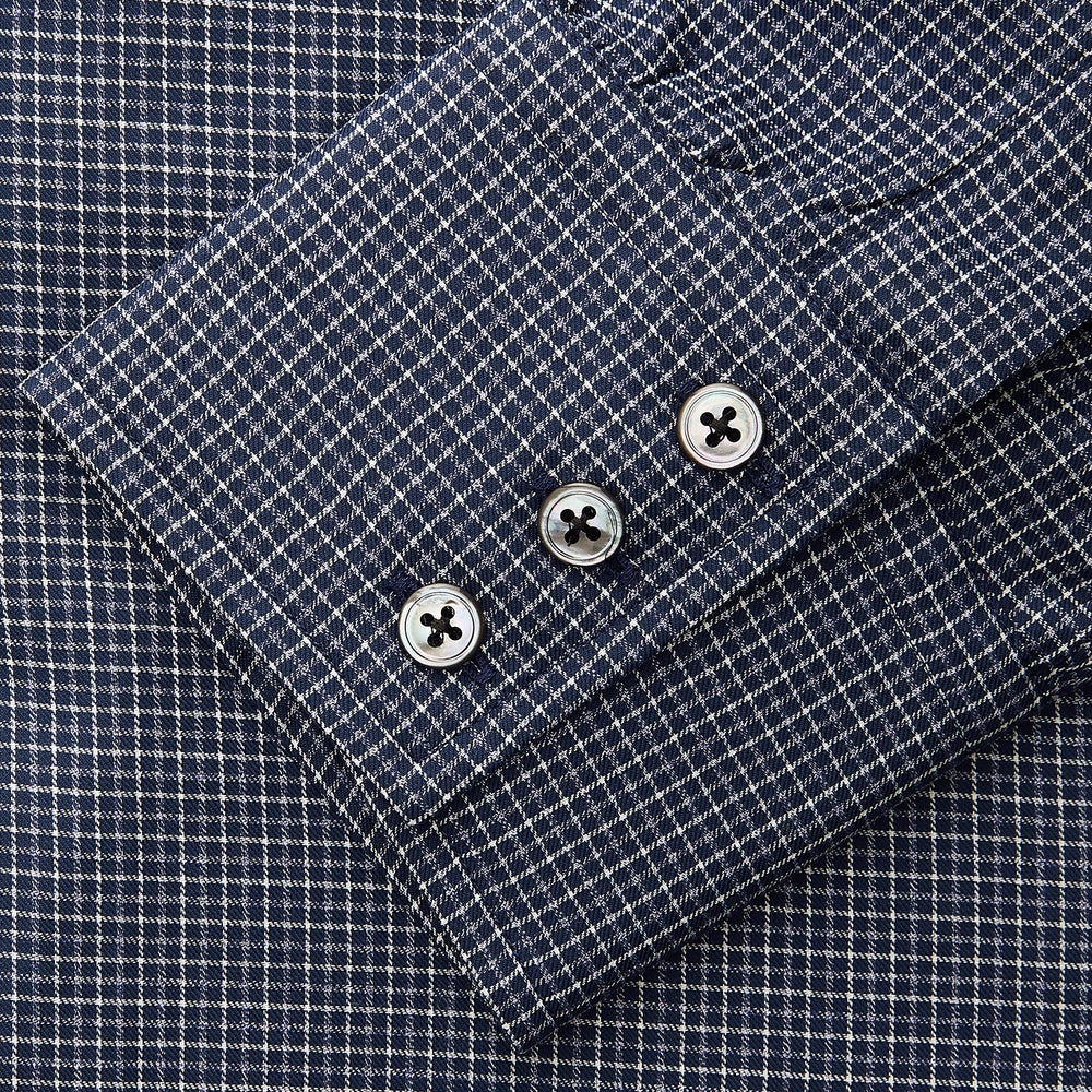 A man in a tie wears the Turnbull & Asser Navy Check Regular Fit Flannel Shirt with T&A collar and 3 button cuffs.