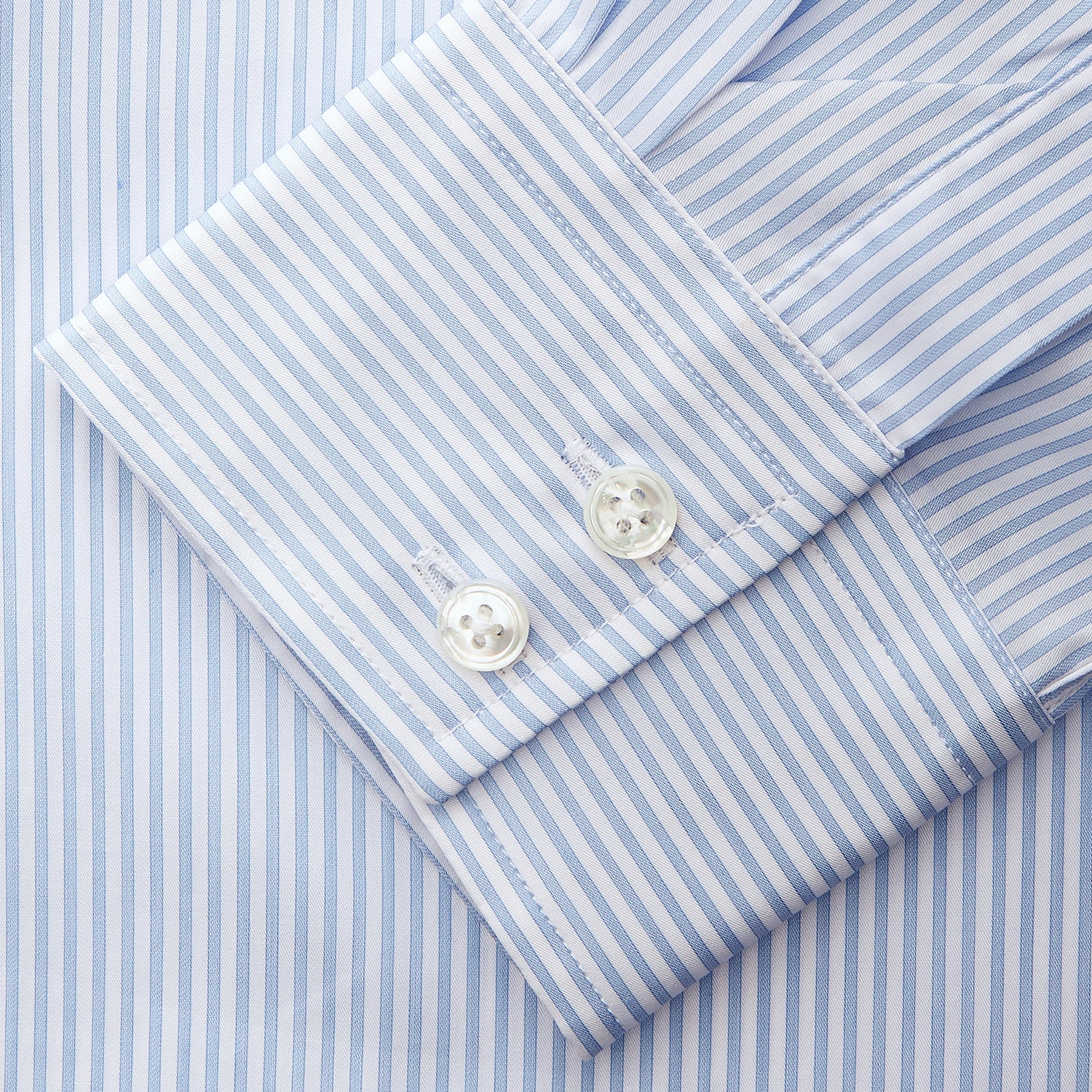 View 3 of product Turnbull & Asser Blue Multi Stripe Tailored Fit Twill Shirt features a Kent collar, 2 button cuffs, and white buttons. Crafted from Italian cotton, it's displayed flat on a white background.