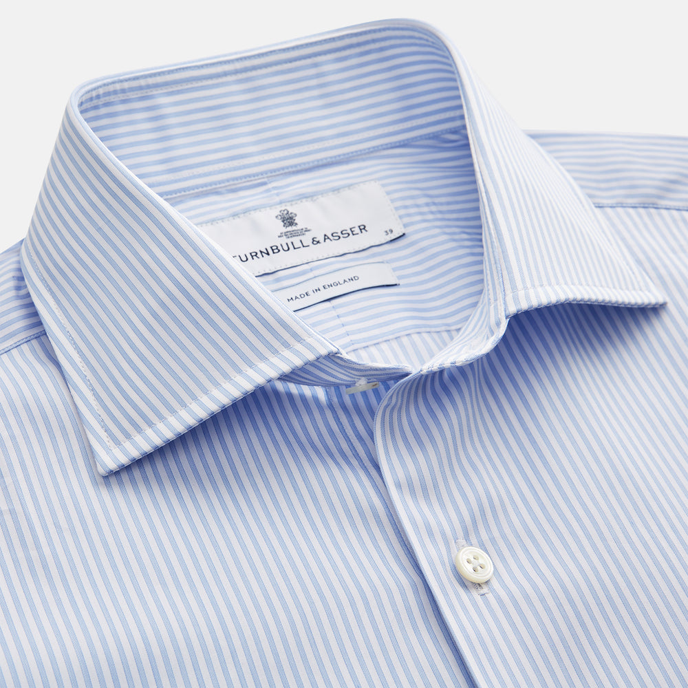 Turnbull & Asser Blue Multi Stripe Tailored Fit Twill Shirt features a Kent collar, 2 button cuffs, and white buttons. Crafted from Italian cotton, it's displayed flat on a white background.