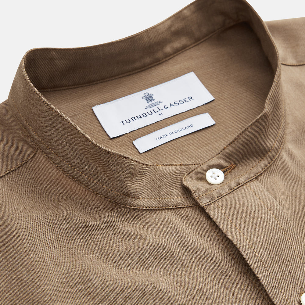 The Turnbull & Asser Brown Military Weekend Fit Cotton & Wool Shirt features a stand collar, 1-button cuffs, and two chest flap pockets; shown laid flat on a white background.
