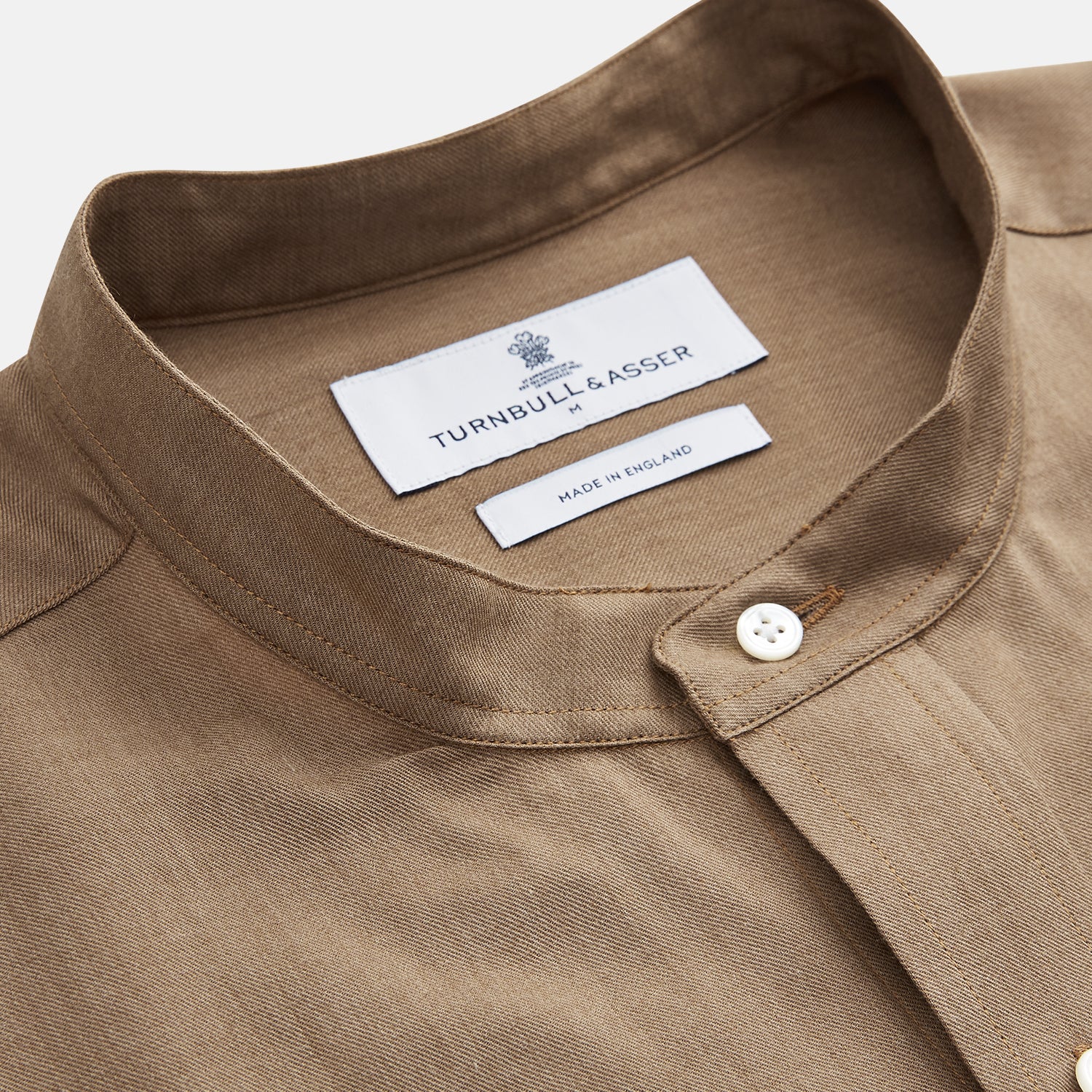 View 3 of product The Turnbull & Asser Brown Military Weekend Fit Cotton & Wool Shirt features a stand collar, 1-button cuffs, and two chest flap pockets; shown laid flat on a white background.
