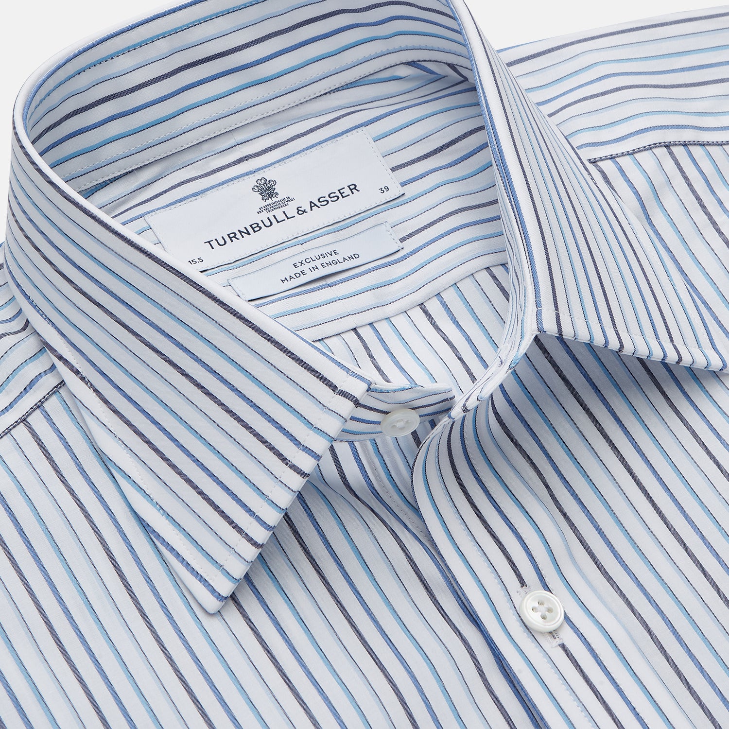 View 2 of product The Turnbull & Asser Blue Multi Blazer Stripe Regular Fit Mayfair Shirt features light blue and white vertical stripes, a signature Mayfair collar, and is neatly displayed on a white background.