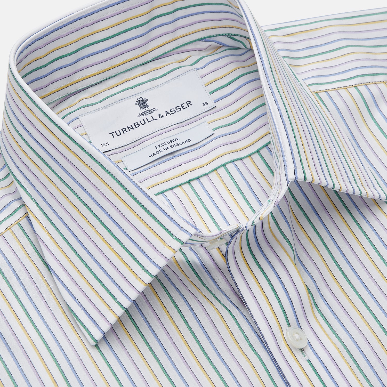 View 2 of product The Turnbull & Asser Yellow Multi Blazer Stripe Regular Fit Mayfair Shirt features a T&A collar and thin blue, yellow, and green stripes on white, shown against a crisp white backdrop.