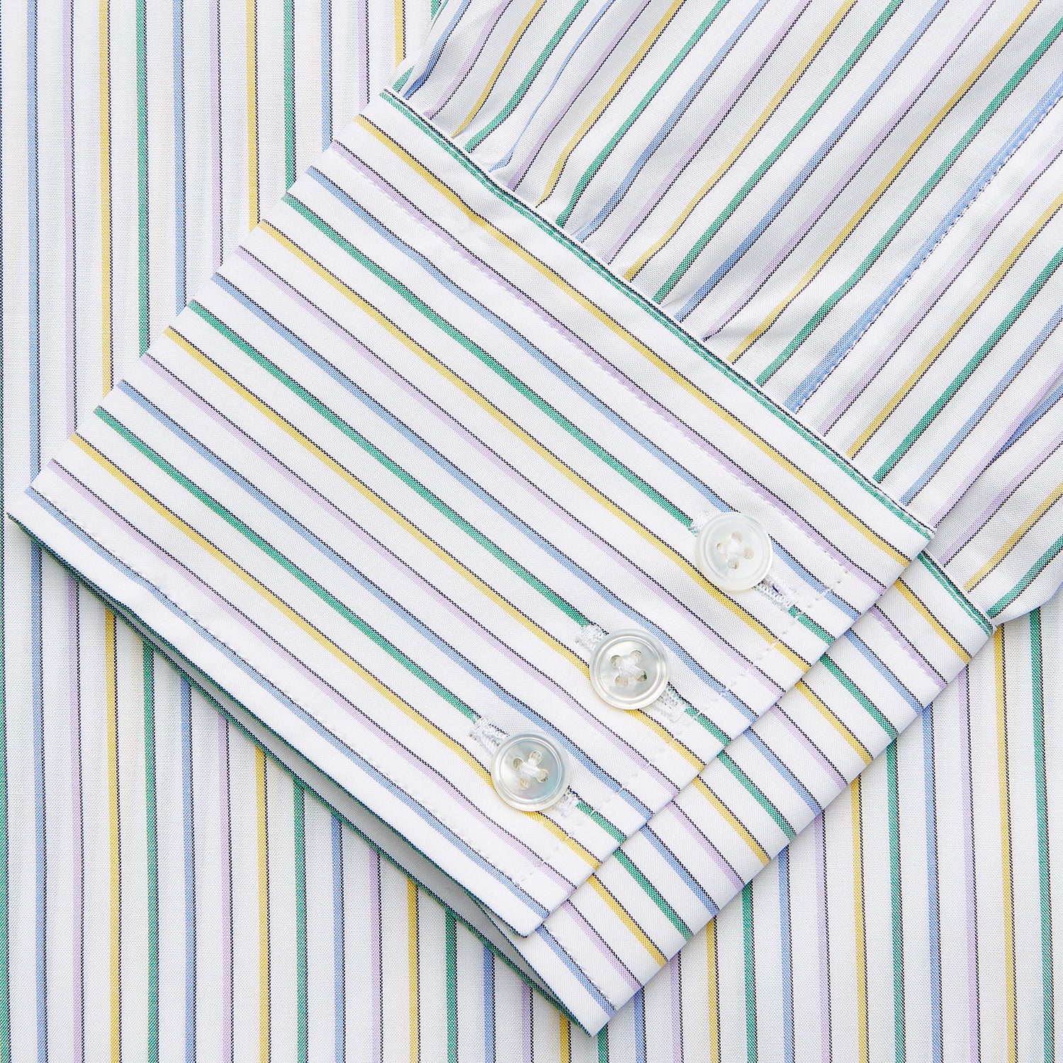 View 3 of product The Turnbull & Asser Yellow Multi Blazer Stripe Regular Fit Mayfair Shirt features a T&A collar and thin blue, yellow, and green stripes on white, shown against a crisp white backdrop.