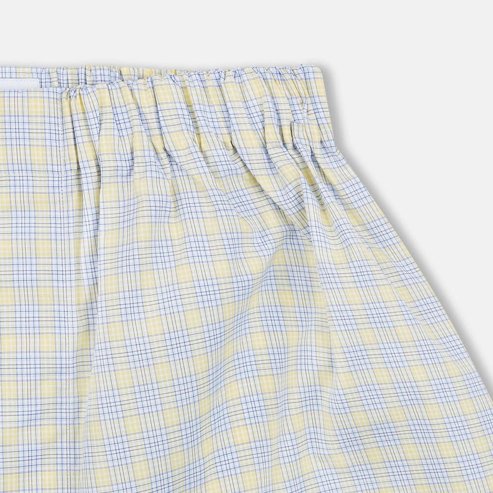 The Turnbull & Asser Yellow Multi Check Cotton Godfrey Boxer Shorts feature a light blue and yellow plaid, soft cotton fabric, and an elastic waistband, shown flat on a white background.