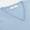 View 2 of product The Turnbull & Asser Pale Blue Cashmere Ifor Slipover is a sleeveless V-neck sweater vest with ribbed edges, shown laid flat on a white background—a classic menswear staple.