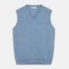 View 1 of product The Turnbull & Asser Pale Blue Cashmere Ifor Slipover is a sleeveless V-neck sweater vest with ribbed edges, shown laid flat on a white background—a classic menswear staple.
