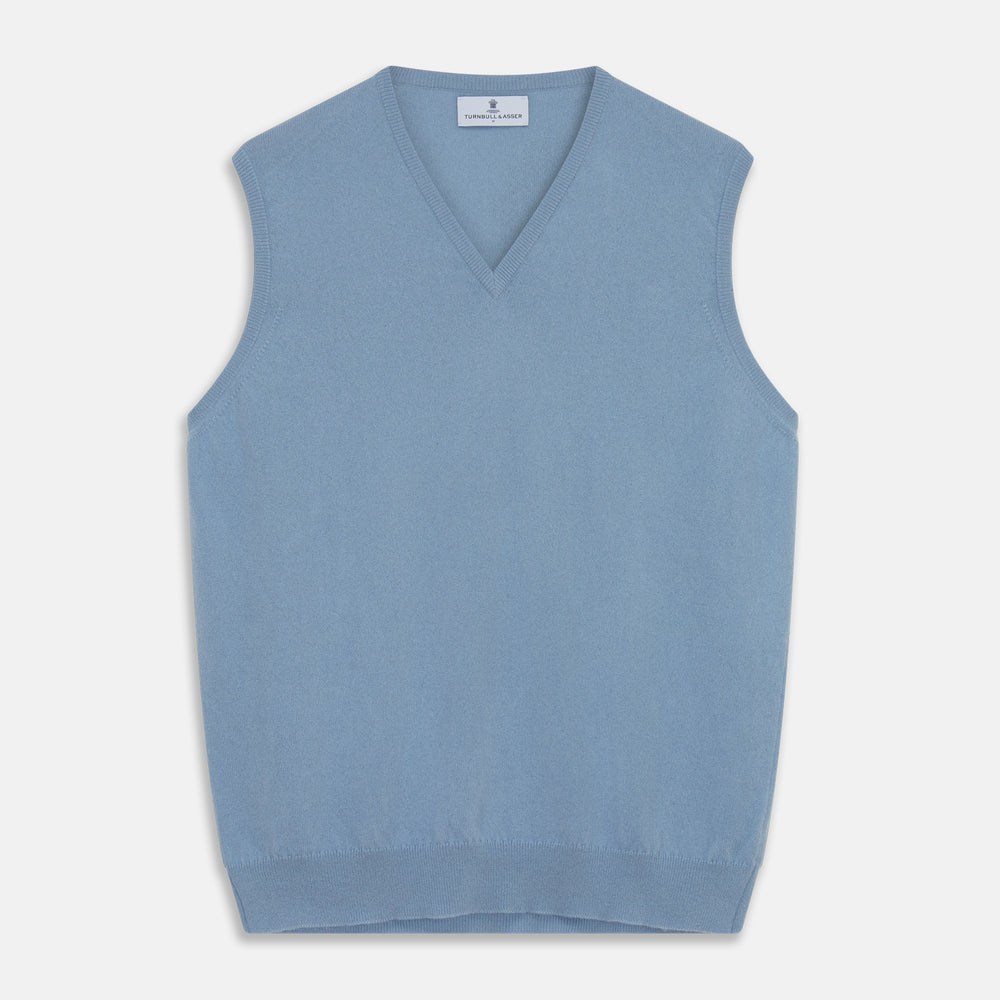 The Turnbull & Asser Pale Blue Cashmere Ifor Slipover is a sleeveless V-neck sweater vest with ribbed edges, shown laid flat on a white background—a classic menswear staple.