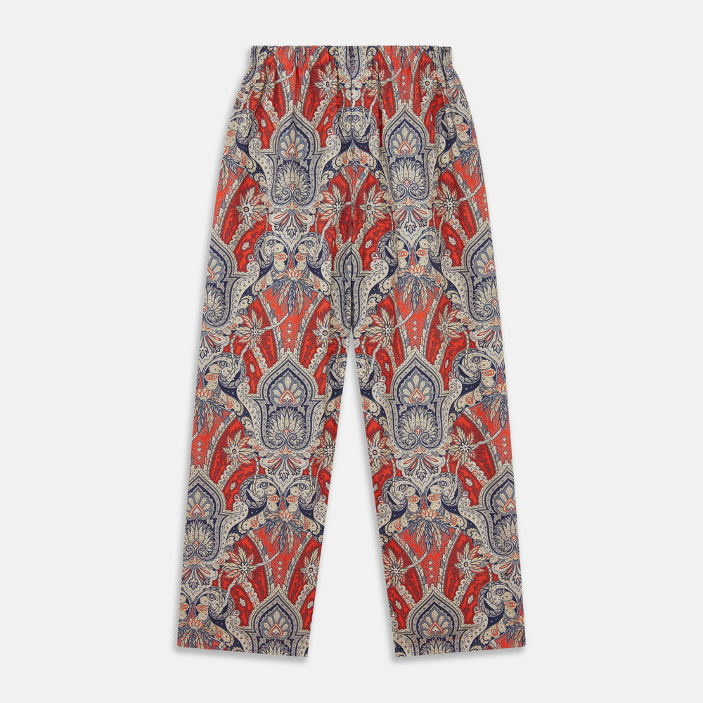 The Turnbull & Asser Red Baroque Silk-Blend Hyde Pyjama Set features a long-sleeve button-up shirt and matching pants in an intricate red, blue, and beige floral-geometric print, displayed flat against a white background.