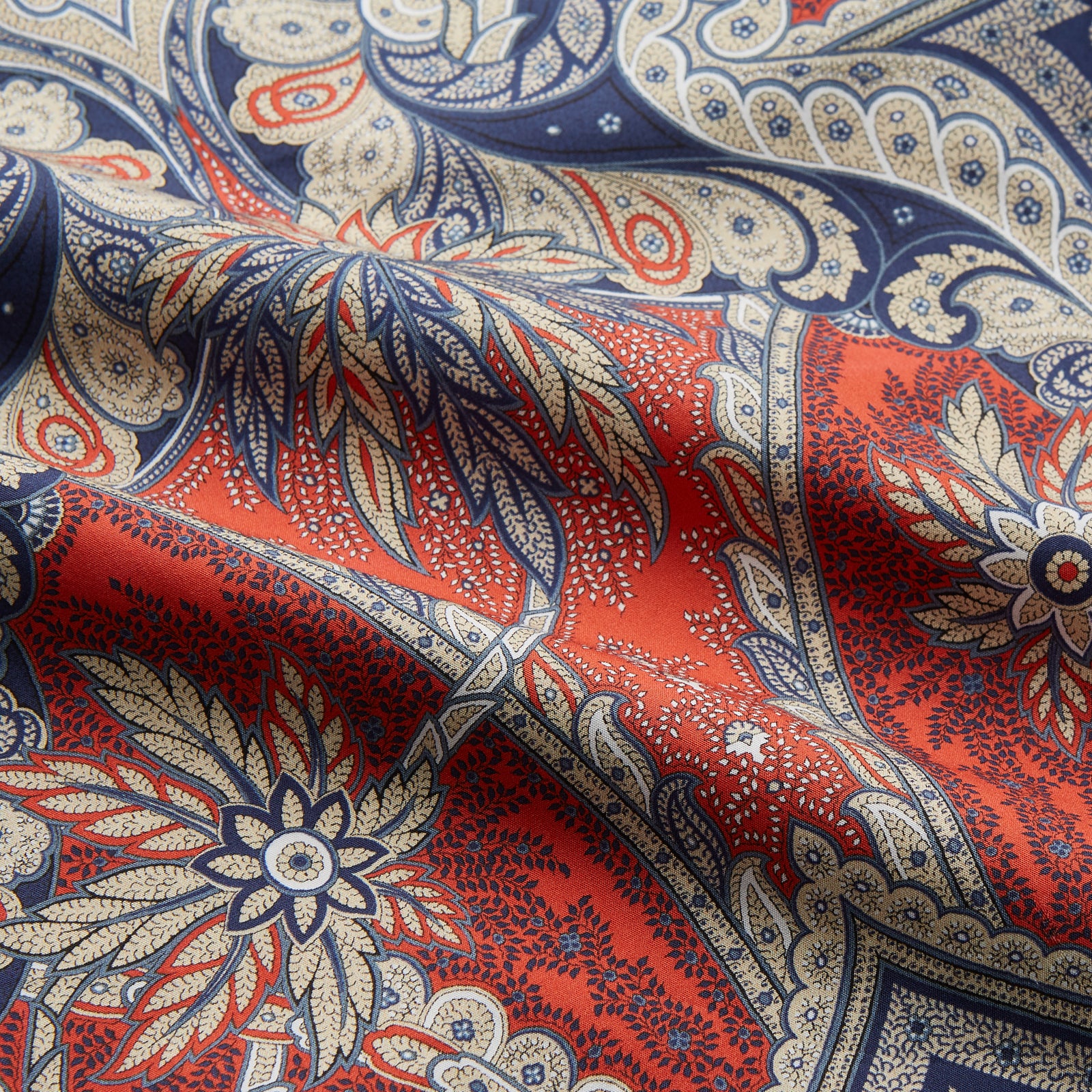 View 3 of product The Turnbull & Asser Red Baroque Silk-Blend Hyde Pyjama Set features a long-sleeve button-up shirt and matching pants in an intricate red, blue, and beige floral-geometric print, displayed flat against a white background.
