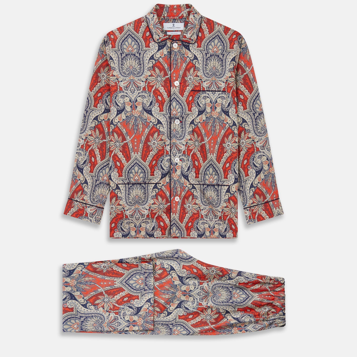 View 1 of product The Turnbull & Asser Red Baroque Silk-Blend Hyde Pyjama Set features a long-sleeve button-up shirt and matching pants in an intricate red, blue, and beige floral-geometric print, displayed flat against a white background.