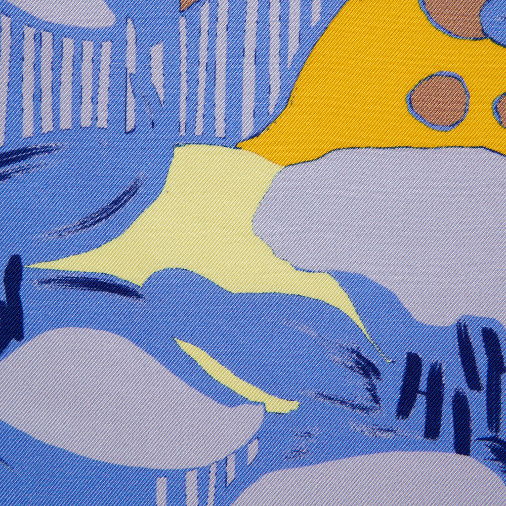The Blue and Yellow Lily Silk Pocket Square by Turnbull & Asser features a vibrant, hand-drawn design of large blue lilies with dark stems on a yellow background adorned with pale blue stripes and tan abstract shapes.