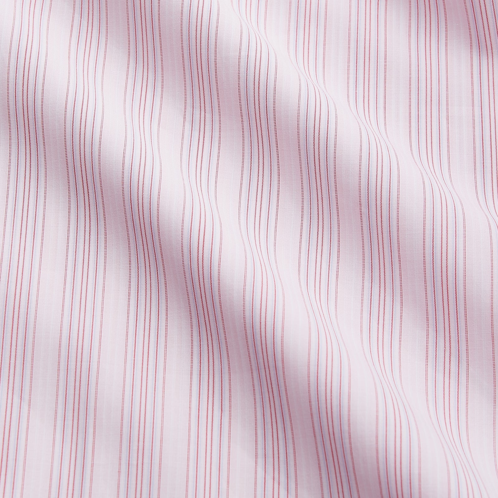 View 4 of product The Pink and Peach Multi Stripe Cotton Regular Fit Whitby Shirt by Turnbull & Asser features long sleeves, double cuffs, a button-down front, and a classic collar; shown laid flat on a white background.
