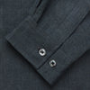 View 2 of product The Turnbull & Asser Grey Cotton and Linen Blend Holiday Fit Winnington Shirt features long sleeves, a spread collar, a left chest pocket, and white buttons, shown against a plain white background.