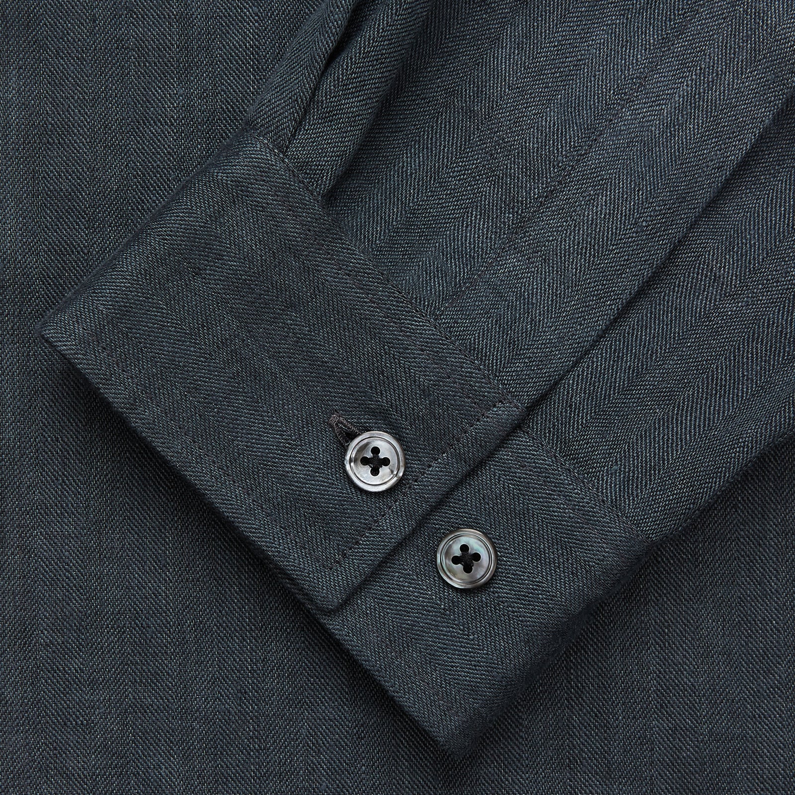View 2 of product The Turnbull & Asser Grey Cotton and Linen Blend Holiday Fit Winnington Shirt features long sleeves, a spread collar, a left chest pocket, and white buttons, shown against a plain white background.