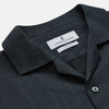 View 4 of product The Turnbull & Asser Grey Cotton and Linen Blend Holiday Fit Winnington Shirt features long sleeves, a spread collar, a left chest pocket, and white buttons, shown against a plain white background.
