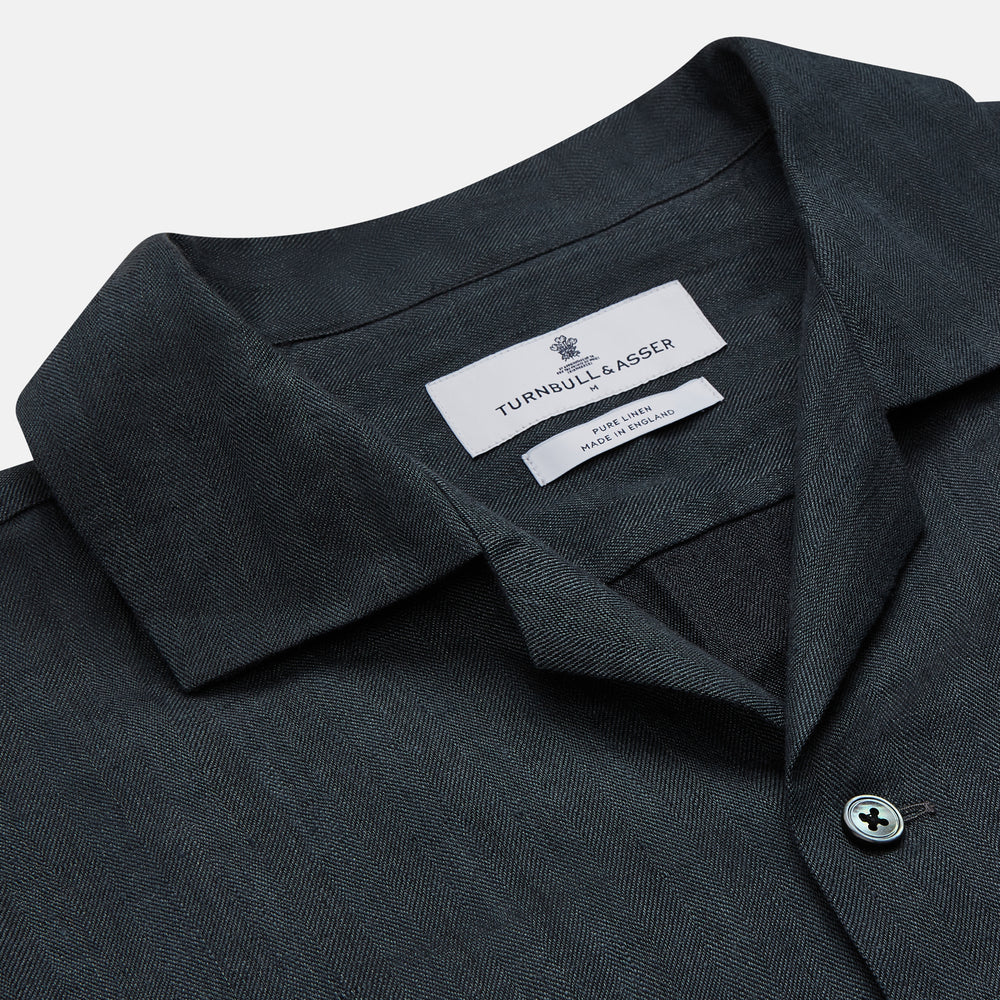 The Turnbull & Asser Grey Cotton and Linen Blend Holiday Fit Winnington Shirt features long sleeves, a spread collar, a left chest pocket, and white buttons, shown against a plain white background.