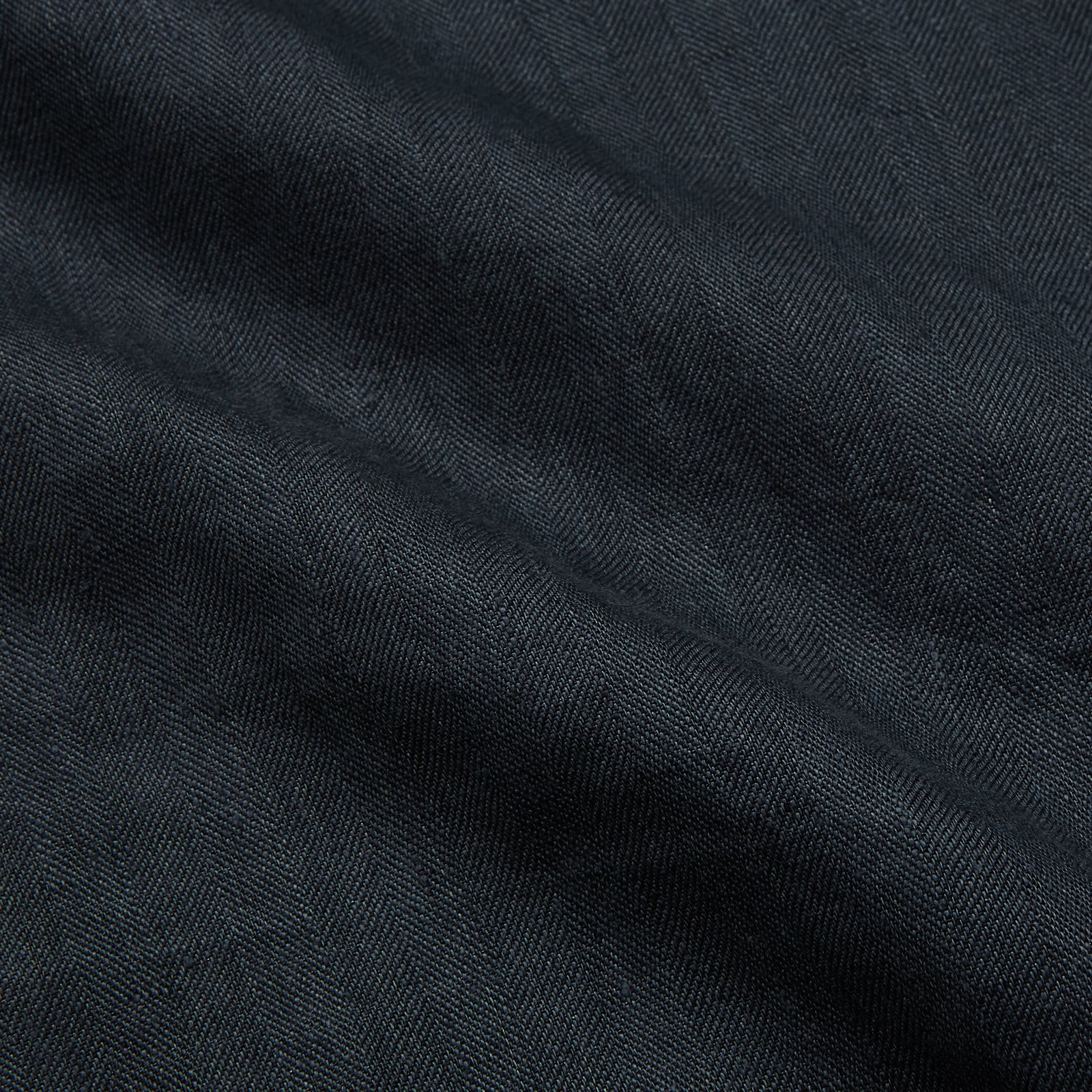 View 3 of product The Turnbull & Asser Grey Cotton and Linen Blend Holiday Fit Winnington Shirt features long sleeves, a spread collar, a left chest pocket, and white buttons, shown against a plain white background.