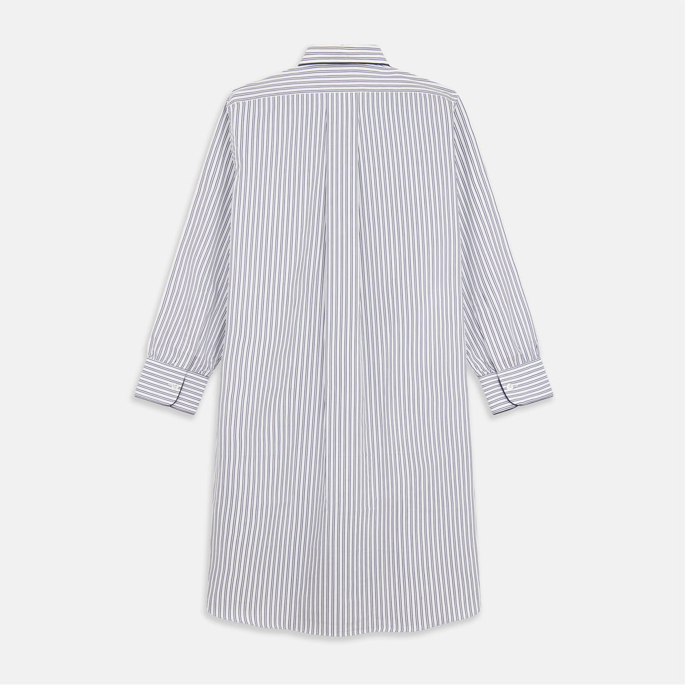 The Turnbull & Asser White and Navy Striped Cotton Sussex Nightshirt features long sleeves, a knee-length cut, a collar, front buttons, a chest pocket with dark trim, and a curved hem for modern comfort inspired by tradition.